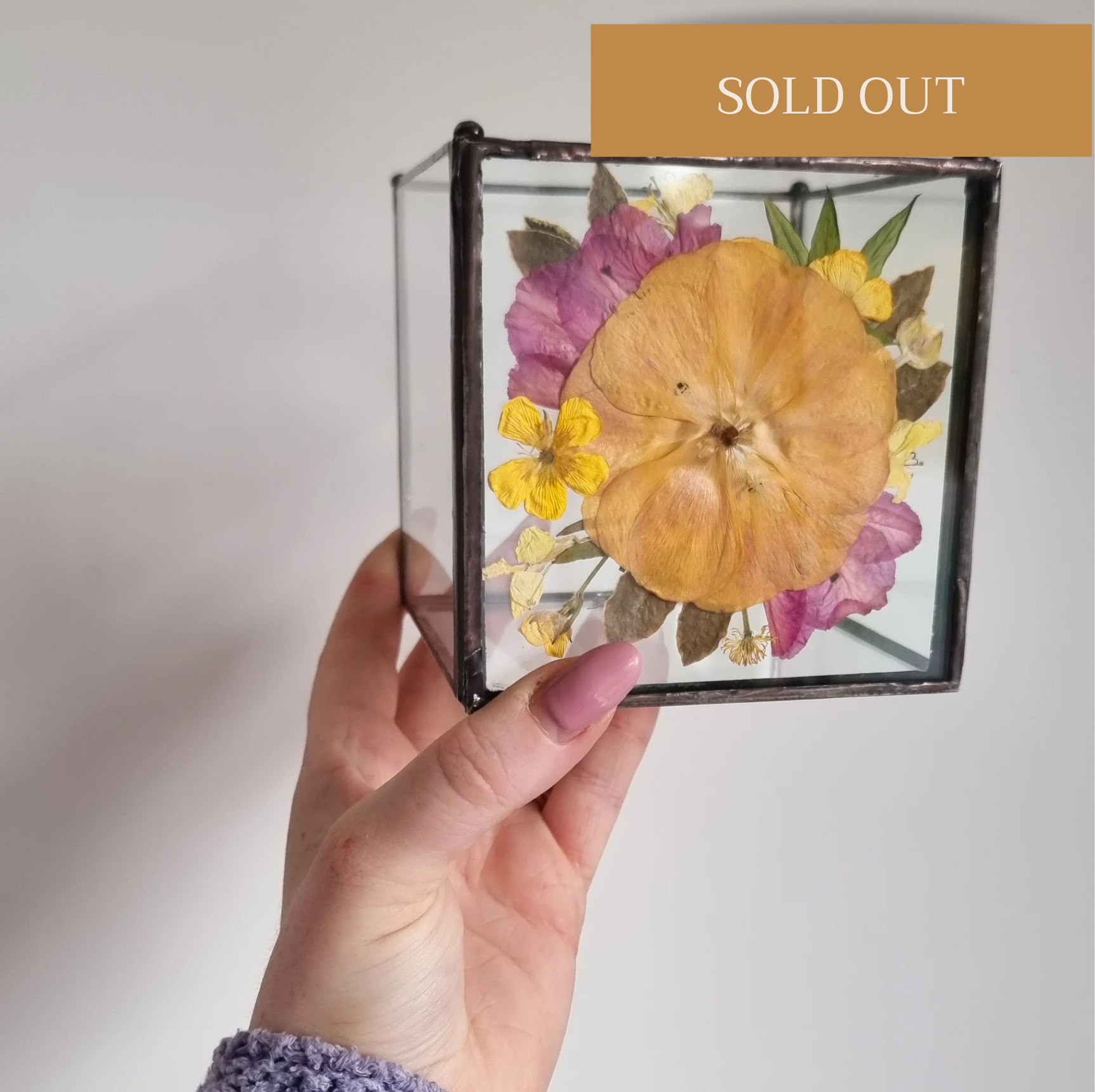 Real pressed and preserved flowers in a handcrafted glass candle holder